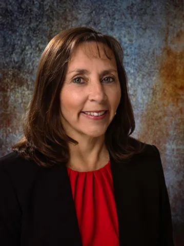 A woman in a red top and black jacket