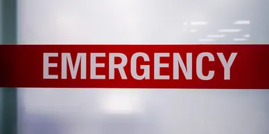 A red emergency sign on the side of a building.