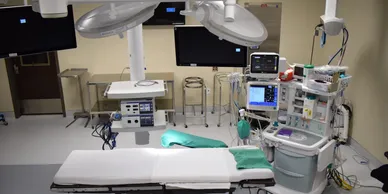 A hospital room with medical equipment and monitors.