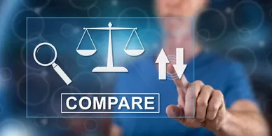 A person touching an image of a scale with the word " compare " above it.