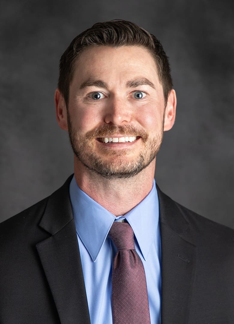 provider in a suit smiling at the camera for a portrait